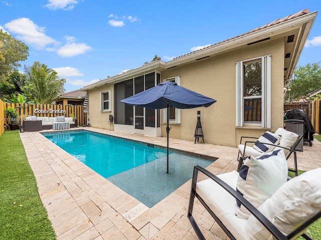 2021 SE 17th Ave, Homestead, FL 33035 - view of swimming pool with outdoor lounge area, a patio, a fenced backyard, and a sunroom