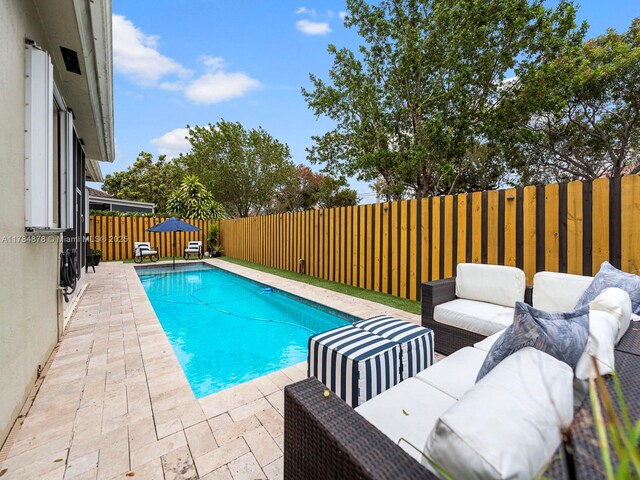 2021 SE 17th Ave, Homestead, FL 33035 - view of swimming pool featuring outdoor lounge area, a fenced backyard, and a patio