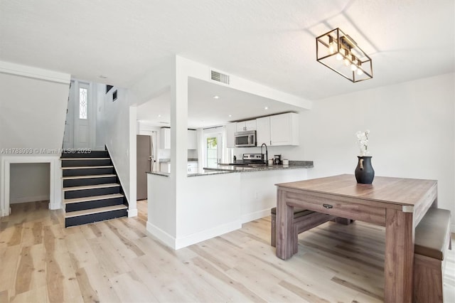 10560 La Placida Dr, Coral Springs, FL 33065 - kitchen featuring appliances with stainless steel finishes, light wood-type flooring, white cabinets, plenty of natural light, and recessed lighting