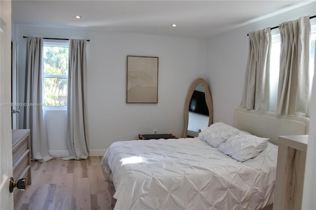 bedroom with light wood-style floors, recessed lighting, and baseboards