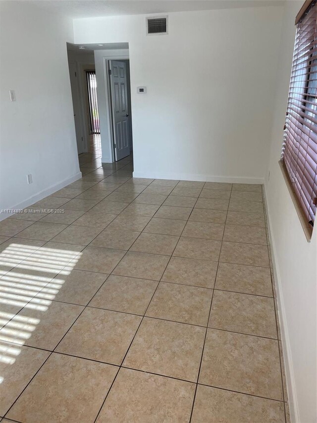 271 NW 57th Ct, Miami, FL 33126 - empty room with light tile patterned floors, visible vents, and baseboards