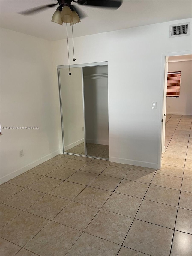 271 NW 57th Ct, Miami, FL 33126 - unfurnished bedroom featuring visible vents, a ceiling fan, a closet, and light tile patterned floors