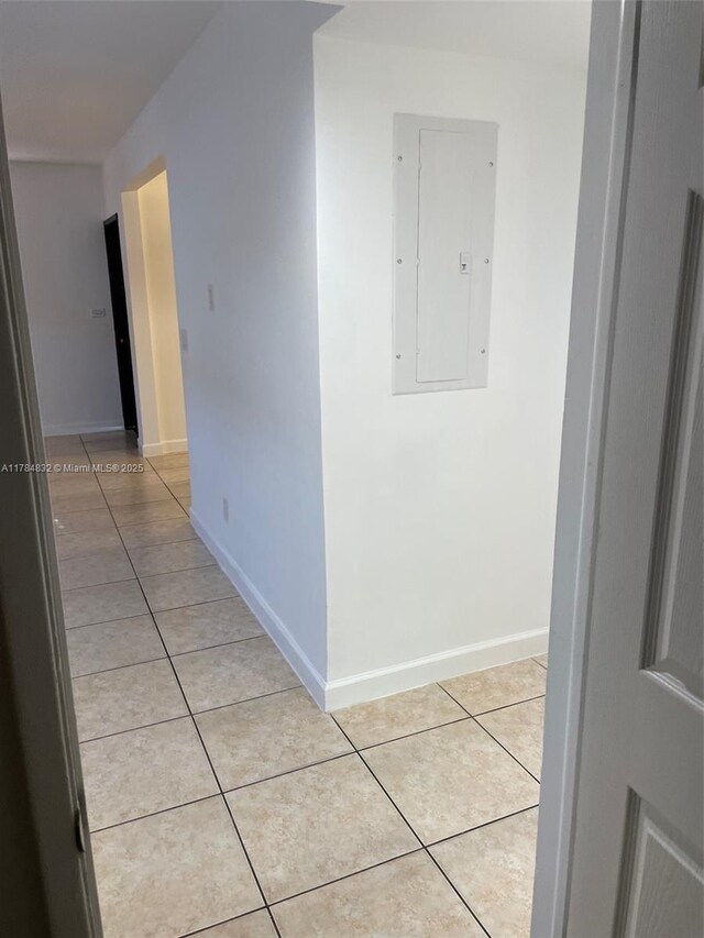 271 NW 57th Ct, Miami, FL 33126 - hall featuring light tile patterned floors, baseboards, and electric panel