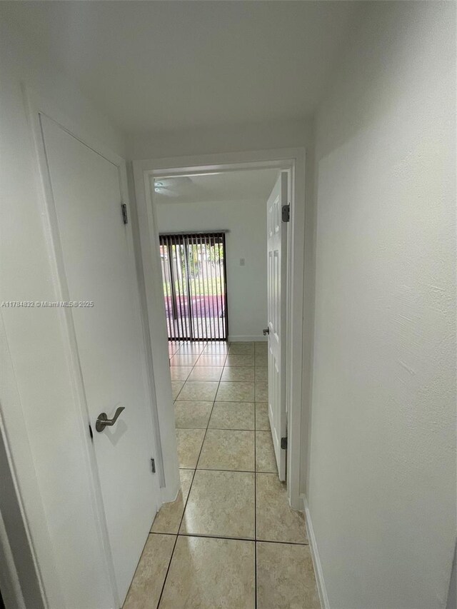 271 NW 57th Ct, Miami, FL 33126 - corridor featuring light tile patterned floors and baseboards