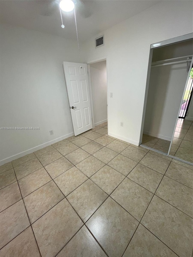 271 NW 57th Ct, Miami, FL 33126 - unfurnished bedroom with baseboards, a closet, light tile patterned floors, a ceiling fan, and visible vents