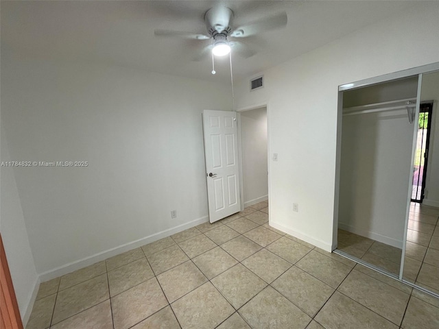 271 NW 57th Ct, Miami, FL 33126 - unfurnished bedroom with visible vents, baseboards, a closet, ceiling fan, and light tile patterned flooring