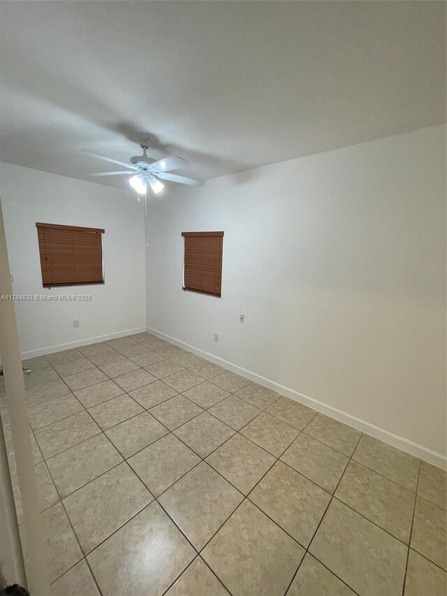 271 NW 57th Ct, Miami, FL 33126 - spare room with baseboards, a ceiling fan, and light tile patterned flooring