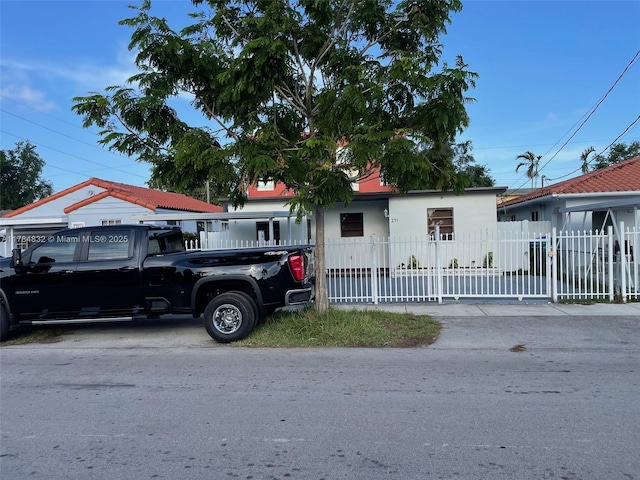 271 NW 57th Ct, Miami, FL 33126 - view of front of house featuring stucco siding and a fenced front yard