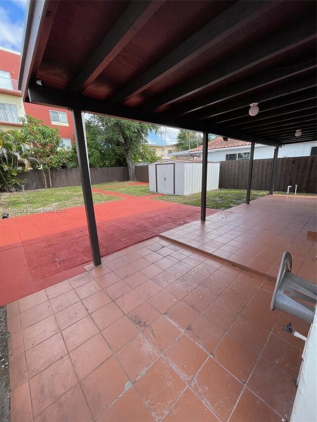 271 NW 57th Ct, Miami, FL 33126 - view of patio / terrace with an outbuilding and fence