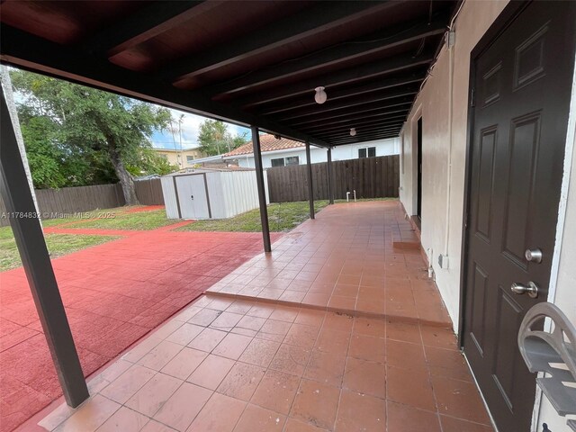 271 NW 57th Ct, Miami, FL 33126 - view of patio with a storage shed, a fenced backyard, and an outdoor structure