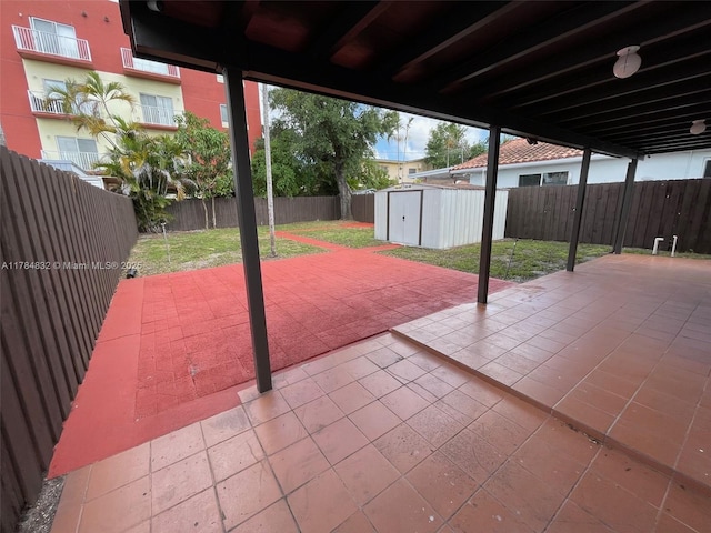 271 NW 57th Ct, Miami, FL 33126 - view of patio / terrace featuring an outbuilding, a shed, and a fenced backyard