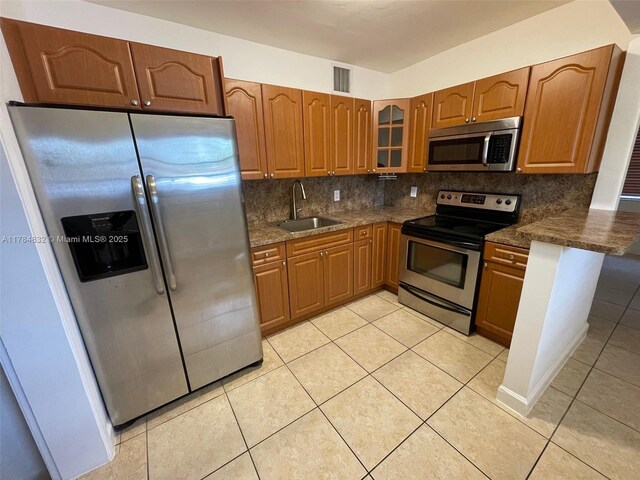 271 NW 57th Ct, Miami, FL 33126 - kitchen with tasteful backsplash, visible vents, brown cabinets, stainless steel appliances, and a sink