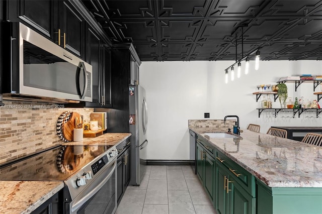 7707 77th Way, West Palm Beach, FL 33407 - kitchen with stainless steel appliances, a sink, decorative backsplash, dark cabinetry, and an ornate ceiling