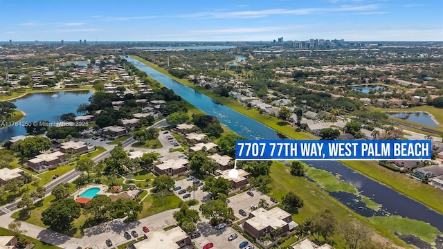 aerial overview of property's location with a nearby body of water and nearby suburban area