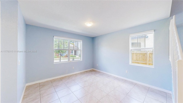 24362 SW 117th Path, Homestead, FL 33032 - spare room featuring light tile patterned floors and baseboards