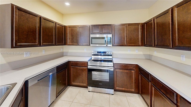 24362 SW 117th Path, Homestead, FL 33032 - kitchen featuring dark brown cabinetry, light tile patterned floors, light countertops, a sink, and stainless steel appliances