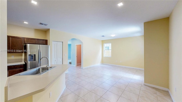 24362 SW 117th Path, Homestead, FL 33032 - kitchen with a sink, light countertops, arched walkways, baseboards, and stainless steel refrigerator with ice dispenser