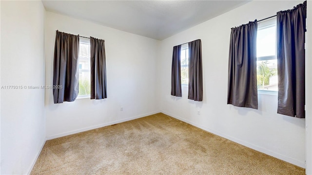 24362 SW 117th Path, Homestead, FL 33032 - empty room featuring baseboards, carpet flooring, and a wealth of natural light