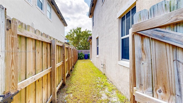 24362 SW 117th Path, Homestead, FL 33032 - view of side of home featuring fence, stucco siding, and a yard
