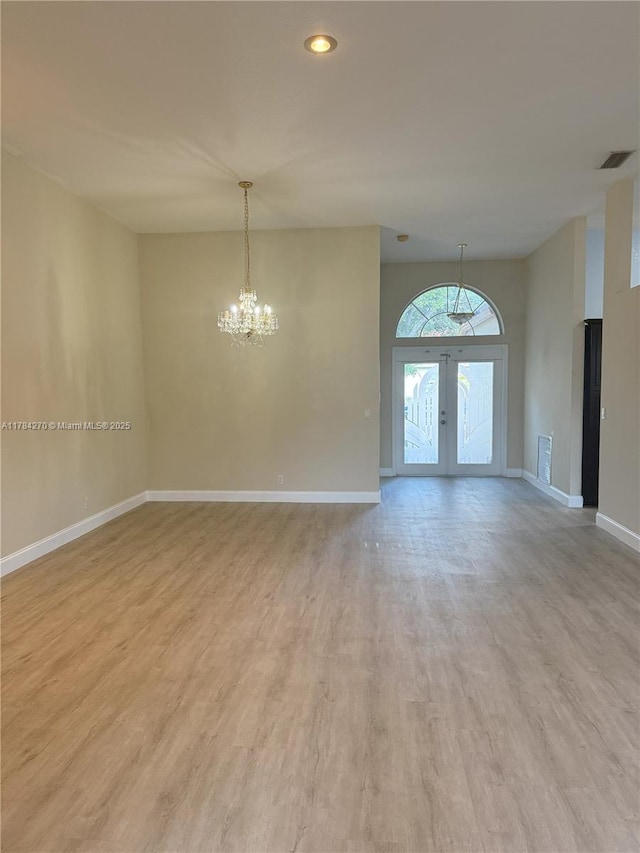 5352 NW 57th Ter, Coral Springs, FL 33067 - empty room with a chandelier, light wood finished floors, french doors, baseboards, and recessed lighting