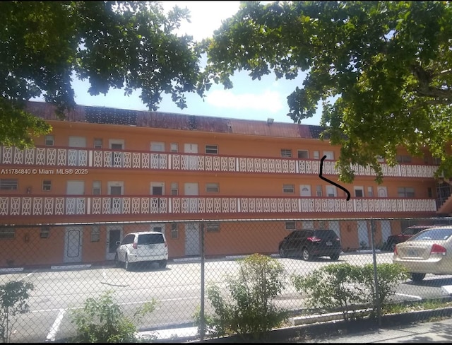 view of building exterior with fence
