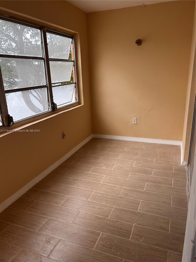 empty room featuring light wood-style flooring and baseboards
