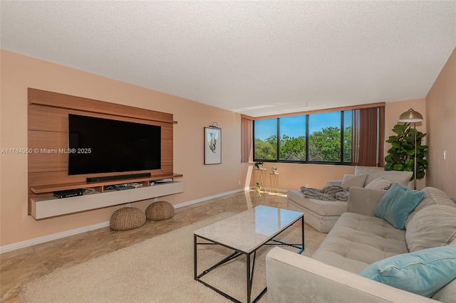 carpeted living room with baseboards and a textured ceiling