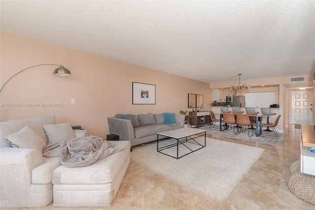 living room with a textured ceiling and visible vents