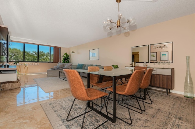 dining room featuring a chandelier, a textured ceiling, and baseboards