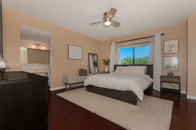 bedroom with dark wood finished floors, baseboards, a textured ceiling, and ceiling fan