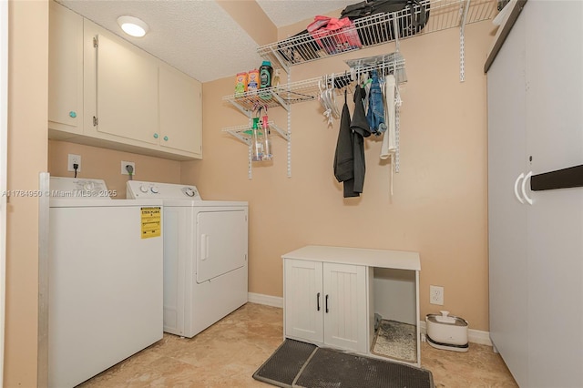 washroom featuring separate washer and dryer, baseboards, and cabinet space
