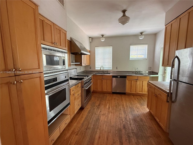 1722 Jefferson Ave, Miami Beach, FL 33139 - kitchen featuring a sink, wall chimney exhaust hood, wood finished floors, and stainless steel appliances