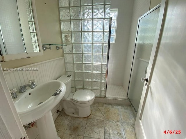 1722 Jefferson Ave, Miami Beach, FL 33139 - bathroom featuring toilet, a stall shower, a healthy amount of sunlight, and a wainscoted wall