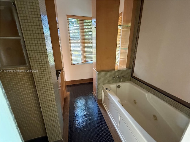 1722 Jefferson Ave, Miami Beach, FL 33139 - bathroom featuring a tub with jets and tile patterned flooring