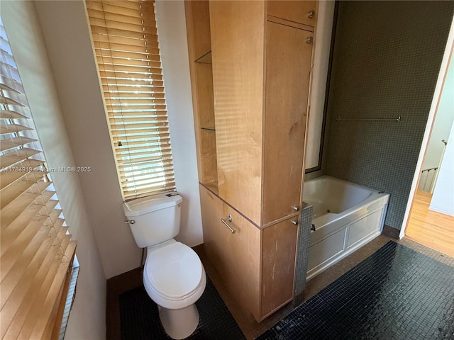 1722 Jefferson Ave, Miami Beach, FL 33139 - bathroom with toilet, tile patterned floors, baseboards, and a bathtub