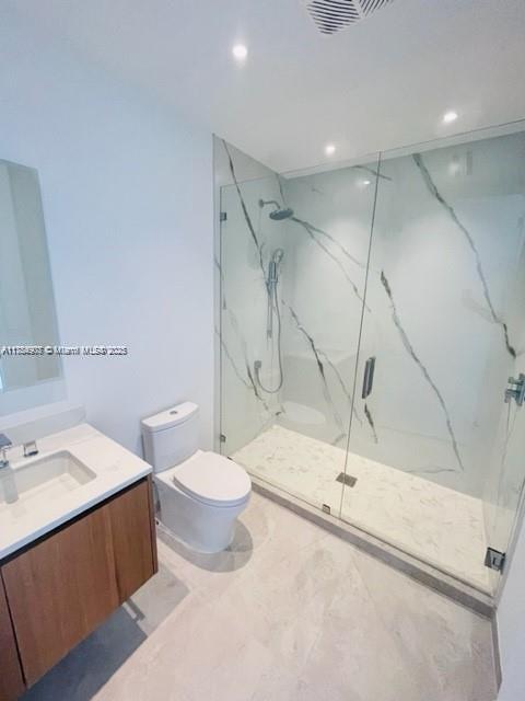 304 Ocean Dr Unit 302, Miami Beach, FL 33139 - full bathroom with a marble finish shower, recessed lighting, toilet, and vanity