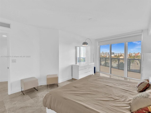 17201 Collins Ave Unit 704, Sunny Isles Beach, FL 33160 - bedroom featuring baseboards, access to exterior, and marble finish floor