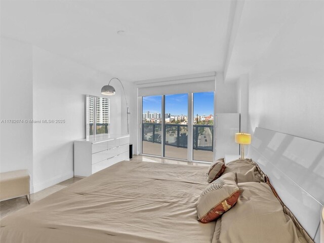 17201 Collins Ave Unit 704, Sunny Isles Beach, FL 33160 - bedroom with access to outside, a city view, baseboards, and visible vents