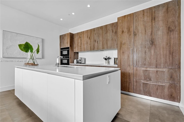 650 NE 32nd St Unit Bh6, Miami, FL 33137 - kitchen featuring modern cabinets, light countertops, recessed lighting, a center island with sink, and brown cabinetry