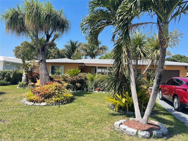 5303 NW 50th Ave, Tamarac, FL 33319 - view of front of property with a garage, stucco siding, and a front lawn