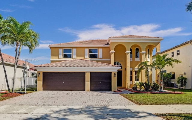 16519 SW 54th Ct, Miramar, FL 33027 - mediterranean / spanish-style home featuring decorative driveway, stucco siding, a tile roof, and a garage