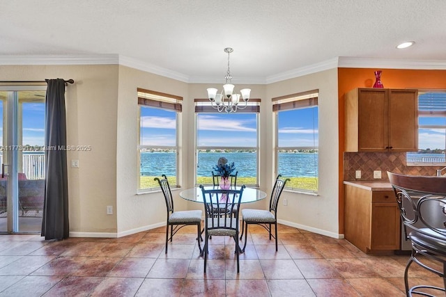 16519 SW 54th Ct, Miramar, FL 33027 - dining area featuring a chandelier, baseboards, a water view, light tile patterned flooring, and crown molding