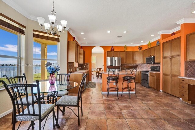 16519 SW 54th Ct, Miramar, FL 33027 - dining room with arched walkways, recessed lighting, crown molding, and a chandelier