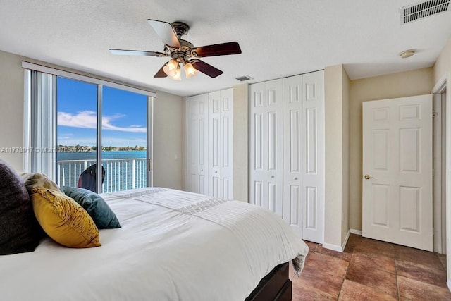 16519 SW 54th Ct, Miramar, FL 33027 - bedroom with access to exterior, multiple closets, a water view, a ceiling fan, and expansive windows
