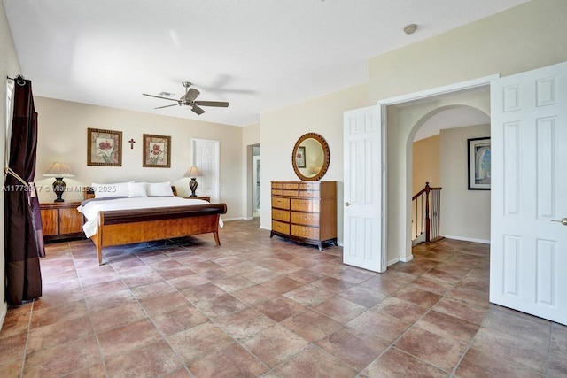 16519 SW 54th Ct, Miramar, FL 33027 - bedroom with arched walkways, light stone finish flooring, and a ceiling fan
