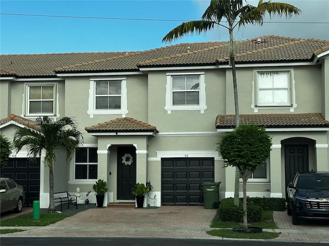 1074 NE 41st Pl, Homestead, FL 33033 - townhome / multi-family property with a garage, a tile roof, stucco siding, and driveway