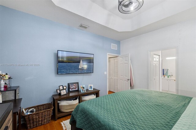 1074 NE 41st Pl, Homestead, FL 33033 - bedroom with wood finished floors and ensuite bathroom