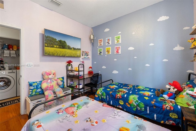 1074 NE 41st Pl, Homestead, FL 33033 - bedroom with independent washer and dryer and wood finished floors