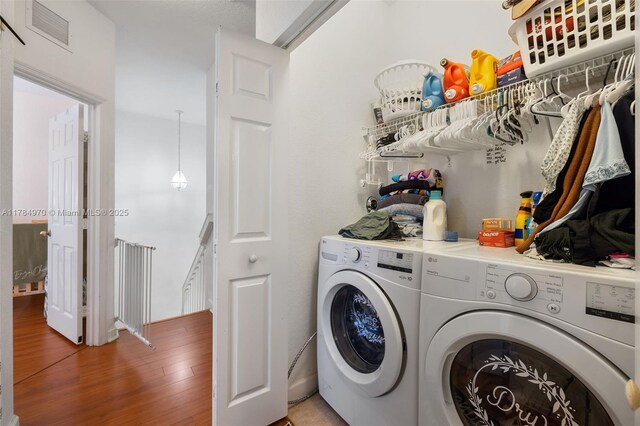 1074 NE 41st Pl, Homestead, FL 33033 - washroom with washer and clothes dryer and wood finished floors