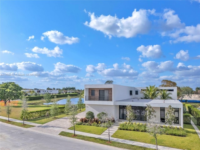 view of front of home featuring a water view and stucco siding